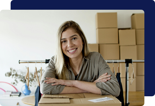 A happy business owner smiling in her organized boutique workspace